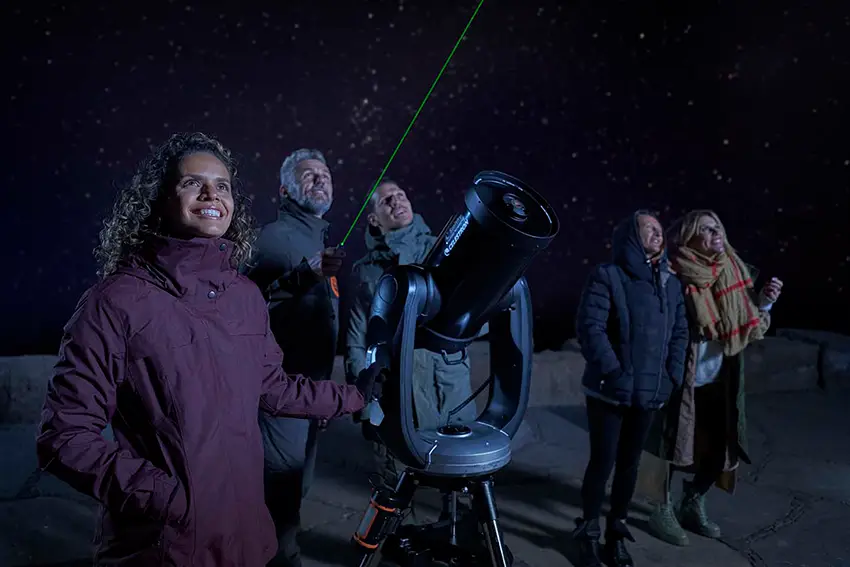 Visitors to the National Park watching the stars on Teide with telescopes and Starlight guides